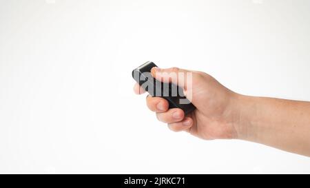 A man's hand holds a bullet control pointing upwards. High quality photo Stock Photo