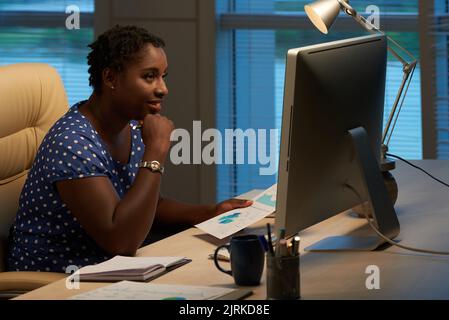 Female business lady working on financial report Stock Photo