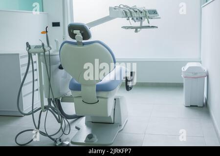 Empty chair with dental tools located in light clean office in modern clinic Stock Photo