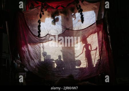 Fabric covering windows with creepy toys decorating room Stock Photo