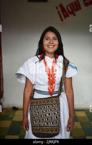 Portrait of happy young Arhuaco indigenous woman in a urban environment, Colombia Stock Photo