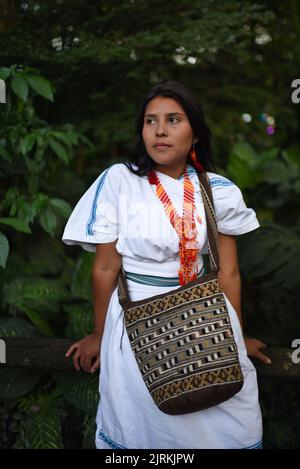 Portrait of contemplative young Arhuaco indigenous woman in a forest of Colombia Stock Photo