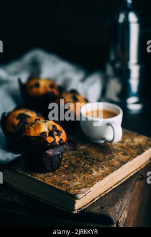 Chocolate muffins and coffee cup on dark background Stock Photo