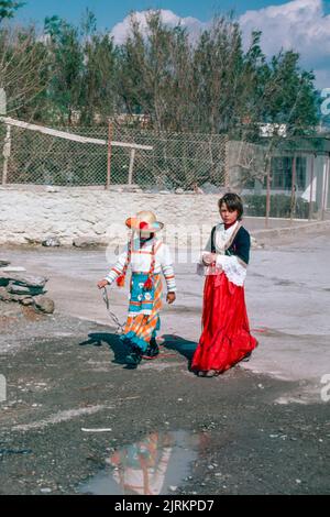 Carnival costumes in Ierapetra, Crete, the largest and most populous of the Greek islands, the centre of Europe's first advanced civilisation. March 1980. Archival scan from a slide. Stock Photo