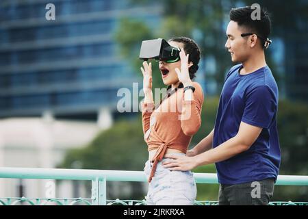 Young Asian woman is amazed by virtual reality Stock Photo