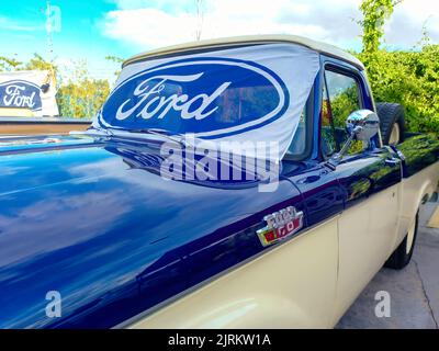 Ford blue oval logo and brand on the windshield of an old F100 V8 utility pickup truck 1963. Expo Fierros 2022 classic car show Stock Photo