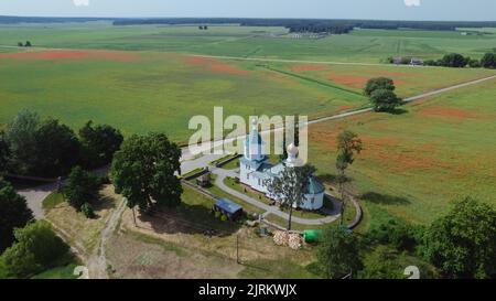 Old stone Orthodox Church in the poppy field, aerial photography Stock Photo