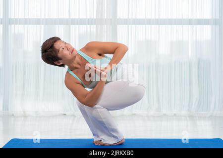 Middle-aged sporty Japanese woman exerising at home Stock Photo