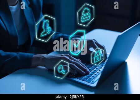 Cyber security expert in business suit using a laptop computer on digital data and network protection job to protect from potential cyber crime. Internet Privacy technology concept with padlock Stock Photo