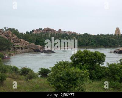 Ghat on the bank of river Tungabhdra and Virupaksha temple at hampi state Karnataka India 08 06 2022 Stock Photo