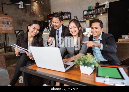 business people meeting in a cafe using laptop Stock Photo