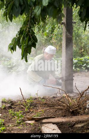 Olomouc Czech republic 9th July 2022 Man covered in dust cutting a concrete pillar using an electric diamond saw, cutter Stock Photo