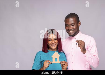 black couple holding key and cardboard house Stock Photo