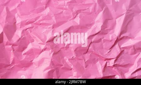 Wrinkled colored paper background texture voluminous pink Stock Photo