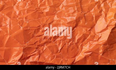 Wrinkled colored paper background texture voluminous orange Stock Photo