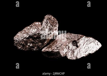 copper ore isolated on black background, used in the production of electrically conductive materials, wires and cables, tin, zinc, metal alloys, brass Stock Photo