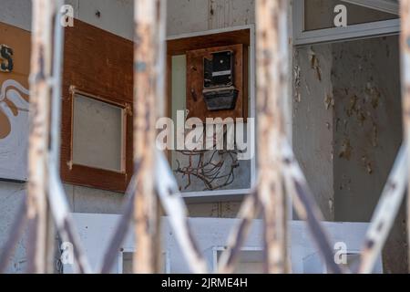 Electrical panel, a selective focus broken electrical panel behind the railing in the abandoned city. Varosha in Famagusta North Cyprus. Stock Photo