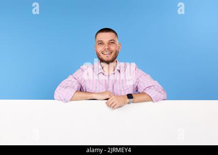 cheerful man holding board with empty copy space Stock Photo