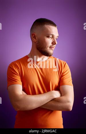 smiling young guy posing with crossed arms Stock Photo