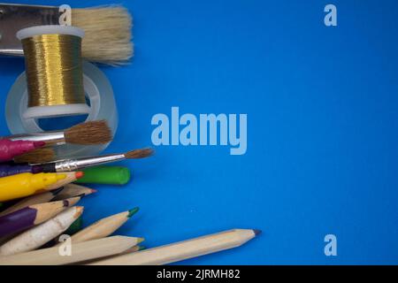 Overhead shot of school supplies, brushes, pencils, artistic tools. Art And Craft Work Tools. Stock Photo