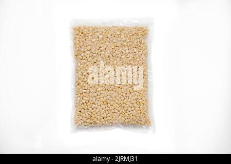 Peeled Pine Nut In Transparent Vacuum Big Plastic Packaging On White Background. Stock Photo