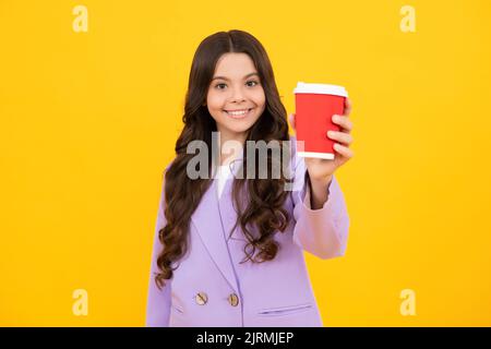Happy smiling school girl holding coffee cup, learning and education. Coffee break and school recess. Back to school. Teenager student plastic Stock Photo