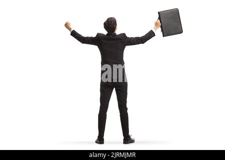 Full length rear view shot of a happy businessman with a briefcase raising hands isolated on white background Stock Photo