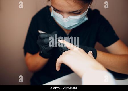 Manicure process female hands finger nails polish. Stock Photo