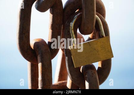 Rusty chain with a padlock in close-up. Safety. Stock Photo