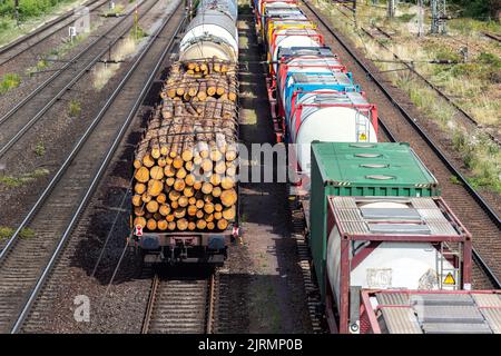 Above view of railway sorting station with many lines directions in Germany. Railroad car wooden timber logs and gas tanks logistics. Raw wood heating Stock Photo