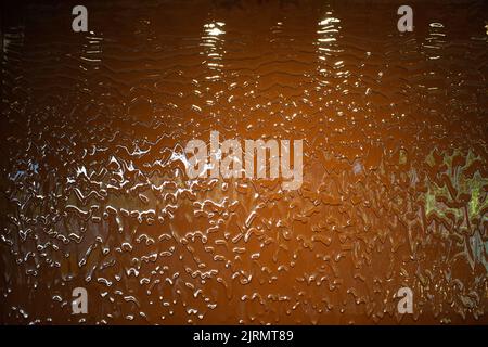 Liquid milk chocolate flowing wall with waves. Stock Photo