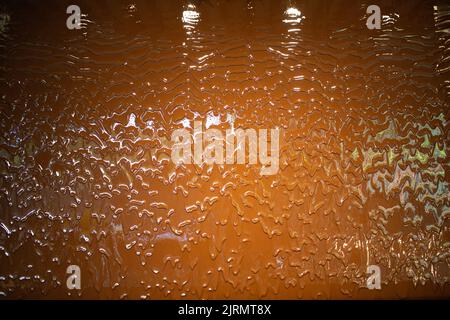 Liquid milk chocolate flowing wall with waves. Stock Photo