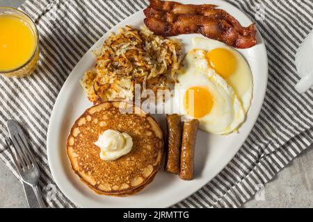 Full Homemade American Pancake Breakfast Brunch with Eggs Bacon and Hashbrowns Stock Photo