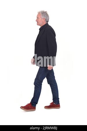 side view of senior man walking on white background Stock Photo