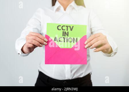 Hand writing sign Cctv In Action. Conceptual photo Selfcontained surveillance system comprising cameras Woman Holding Tablet With Power Button Sign Stock Photo