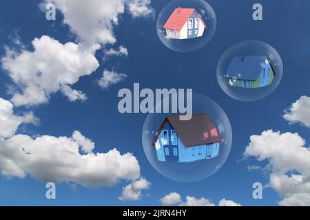 Symbol image real estate bubble: Soap bubbles with single-family homes against a blue sky Stock Photo