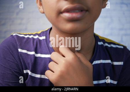 teenage boy suffering throat pain close up  Stock Photo
