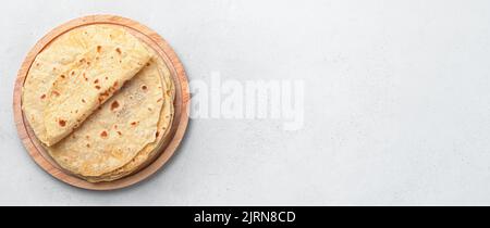 Fresh, Indian chapati cakes on a gray background. Top view, copy space. Stock Photo