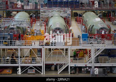 24 August 2022, Hamburg: Airbus employees work on the A320 fuselages in ...