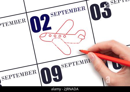 2nd day of September. A hand drawing outline of airplane on calendar date 2 September . The date of flight on plane. Travel, business trips. Autumn mo Stock Photo