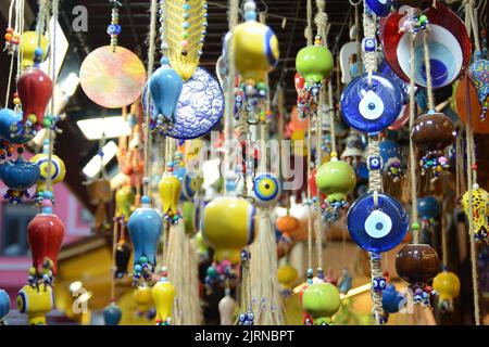 Multi-colored wall and ceiling retro  ornaments, various ceramics and threads and trinkets hung on the wall Stock Photo