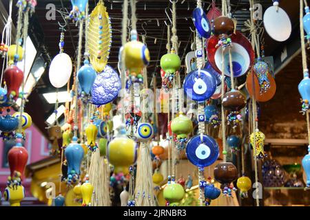 Multi-colored wall and ceiling retro  ornaments, various ceramics and threads and trinkets hung on the wall Stock Photo
