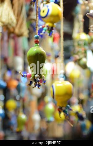 Multi-colored wall and ceiling retro  ornaments, various ceramics and threads and trinkets hung on the wall Stock Photo