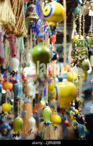 Multi-colored wall and ceiling retro  ornaments, various ceramics and threads and trinkets hung on the wall Stock Photo