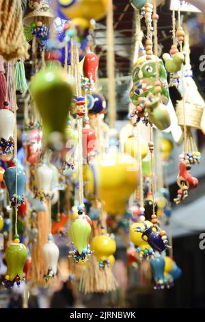Multi-colored wall and ceiling retro  ornaments, various ceramics and threads and trinkets hung on the wall Stock Photo