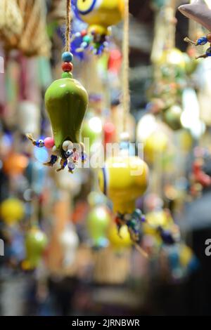 Multi-colored wall and ceiling retro  ornaments, various ceramics and threads and trinkets hung on the wall Stock Photo