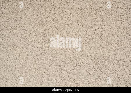 Structural plaster wall in beige color. Creative vintage background. Stock Photo