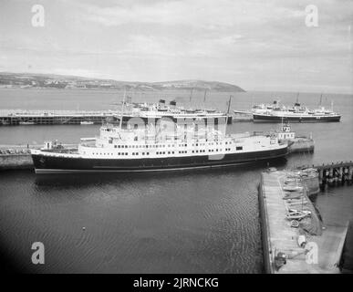 1950s, historical, the steamship, Ben-my-Chree moored in a habour. She was a passenger ferry built in 1927 at the Cammell Laird shipyard, Birkenhead, Liverpool, for the  Isle of Man Steam Packet Company.  Requisitioned for service in WW2, as a transport ship, she made three trips to Dunkirk and rescued over 4,000 troops. After the war, she was refitted and her funnel shortened and she remained in service until 1965. Stock Photo