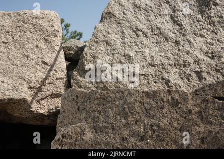 Structure of granite. Large stones on the seashore. Creative vintage background. Stock Photo