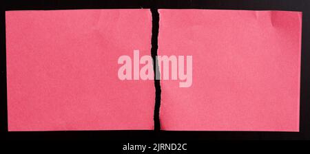 Red torn paper on black background Stock Photo